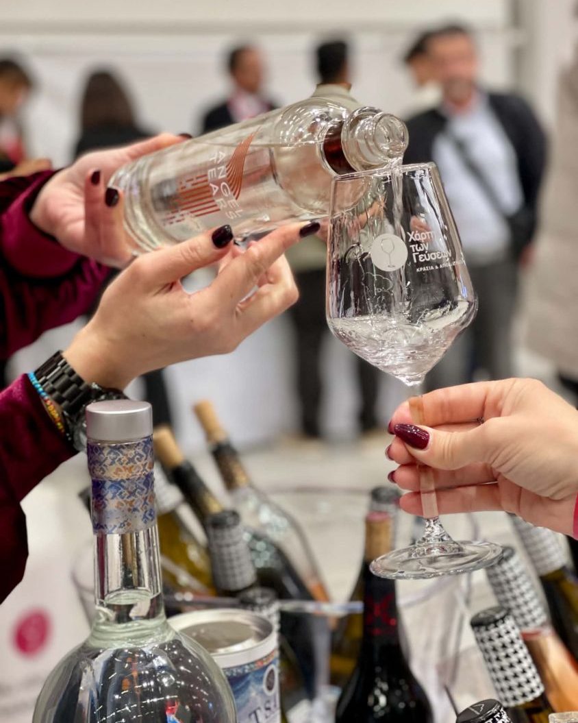 Clear spirit poured into a tasting glass at a Greek wine and spirits fair